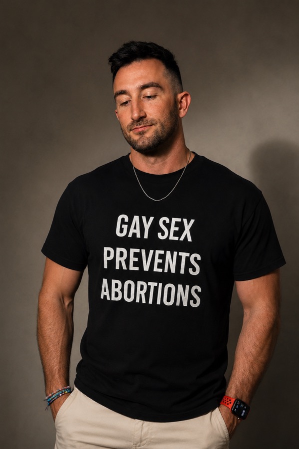 Person wearing a black t-shirt printed with the words GAY SEX PREVENTS ABORTIONS in white block lettering